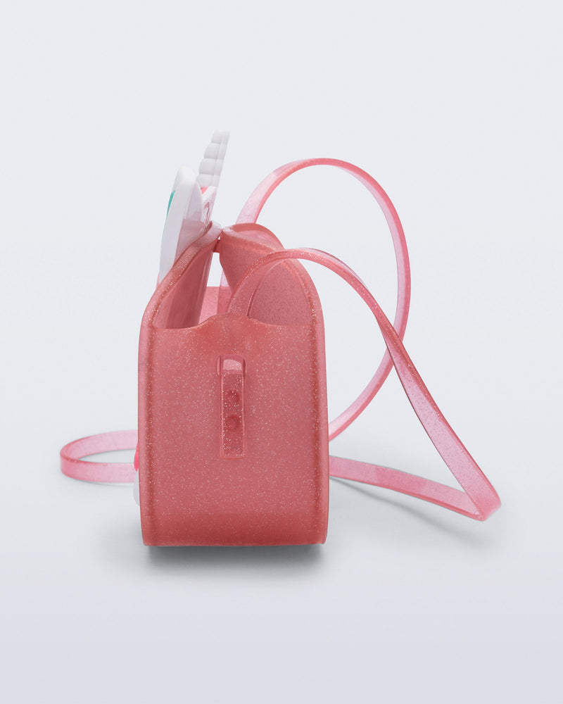 Side view of a pink glitter Dreamy Unicorn kids bag with a unicorn face on front with pink hair