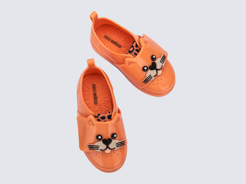 Top view of a pair of orange Jelly Pop Safari baby sneakers