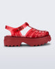 Side view of a transparent red Possession Platform II sandal