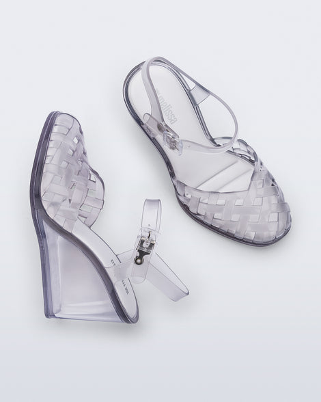 Side and top view of a pair of clear grey Agata wedge heel sandals with ankle strap