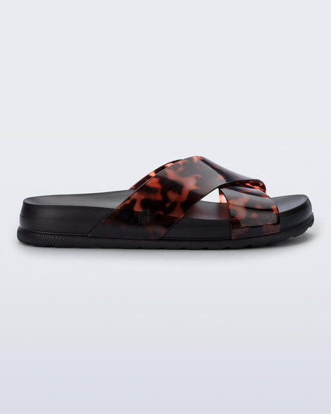 Side view of a black/tortoise Cozy Cross sandal with crisscross top straps