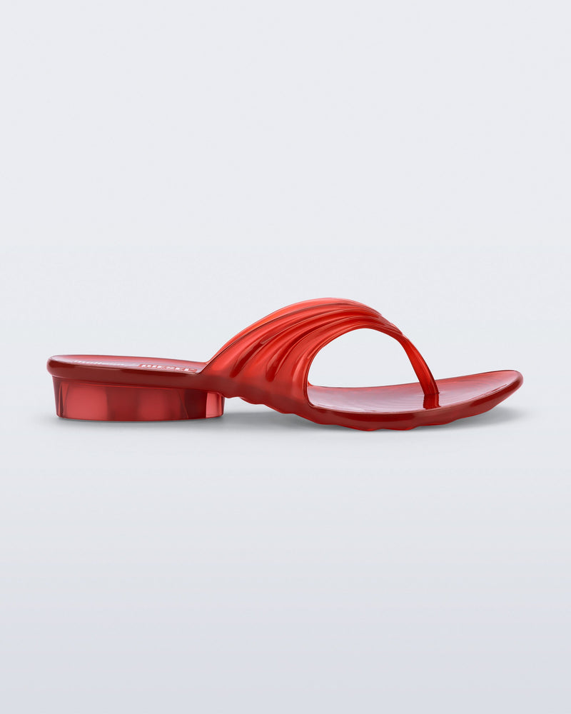 Side view of a transparent red Flip Flop + Diesel sandals