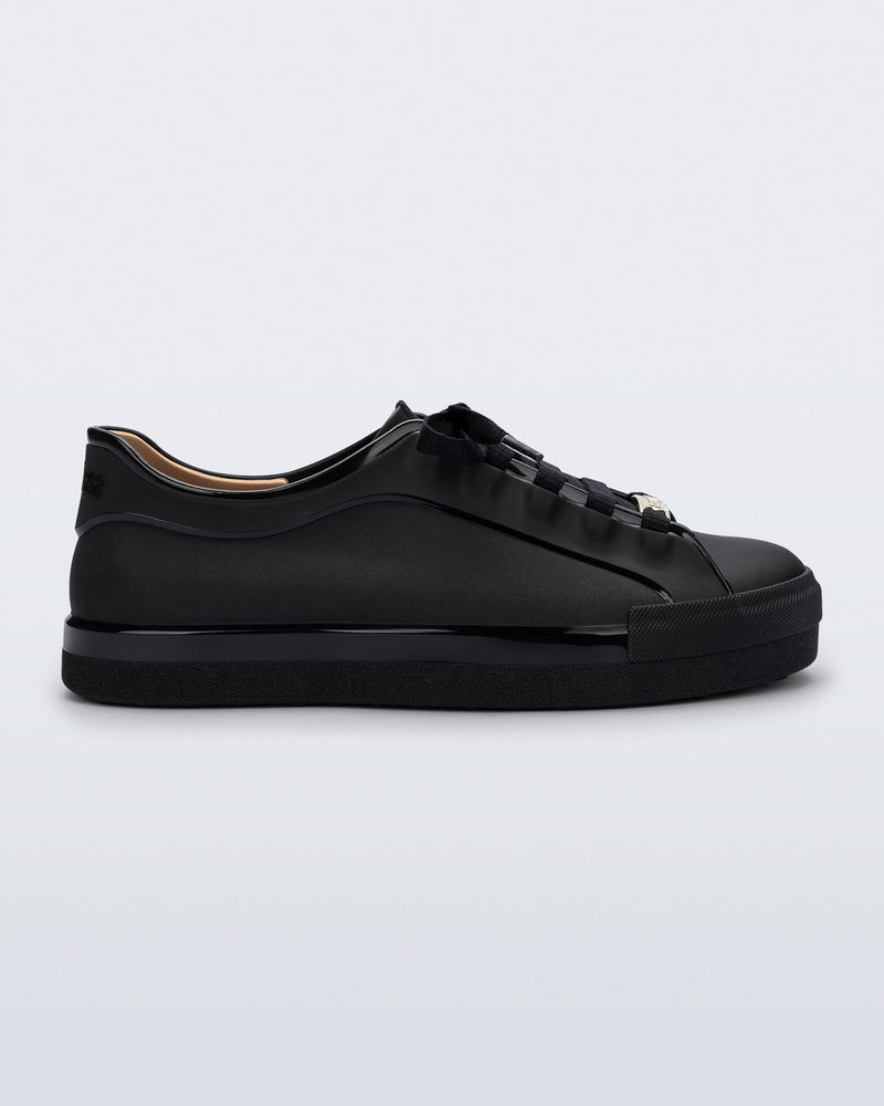 Side view of a black Wow Sneaker with black shoe laces