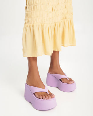Model's legs wearing a pair of lilac Free Thong  Wedge Platform heels