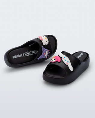 Top and angled view of a pair of black Free Platform slides + Hello Kitty and Friends kids sandals with Hello Kitty and Friends on upper