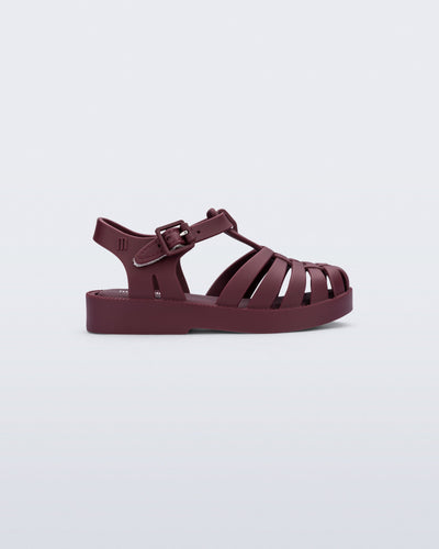 Side view of a matte burgundy Possession baby fisherman sandal.