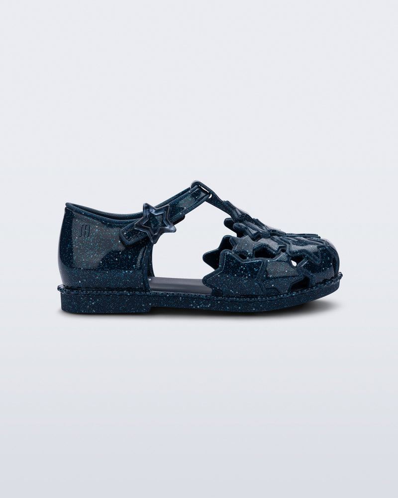 Side view of a glitter blue Starry baby sandal