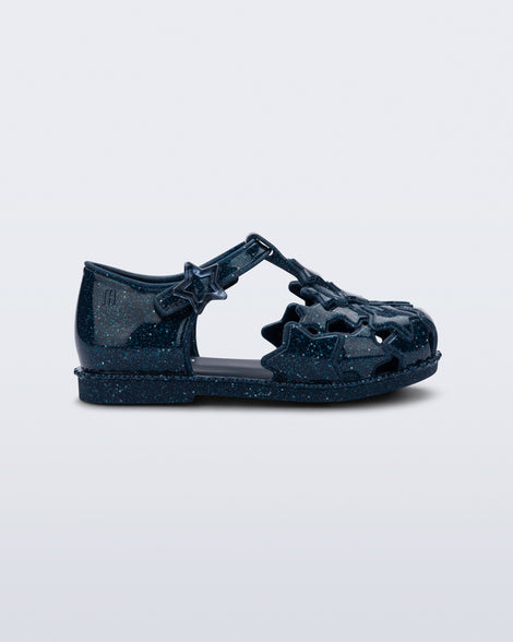 Side view of a glitter blue Starry baby sandal