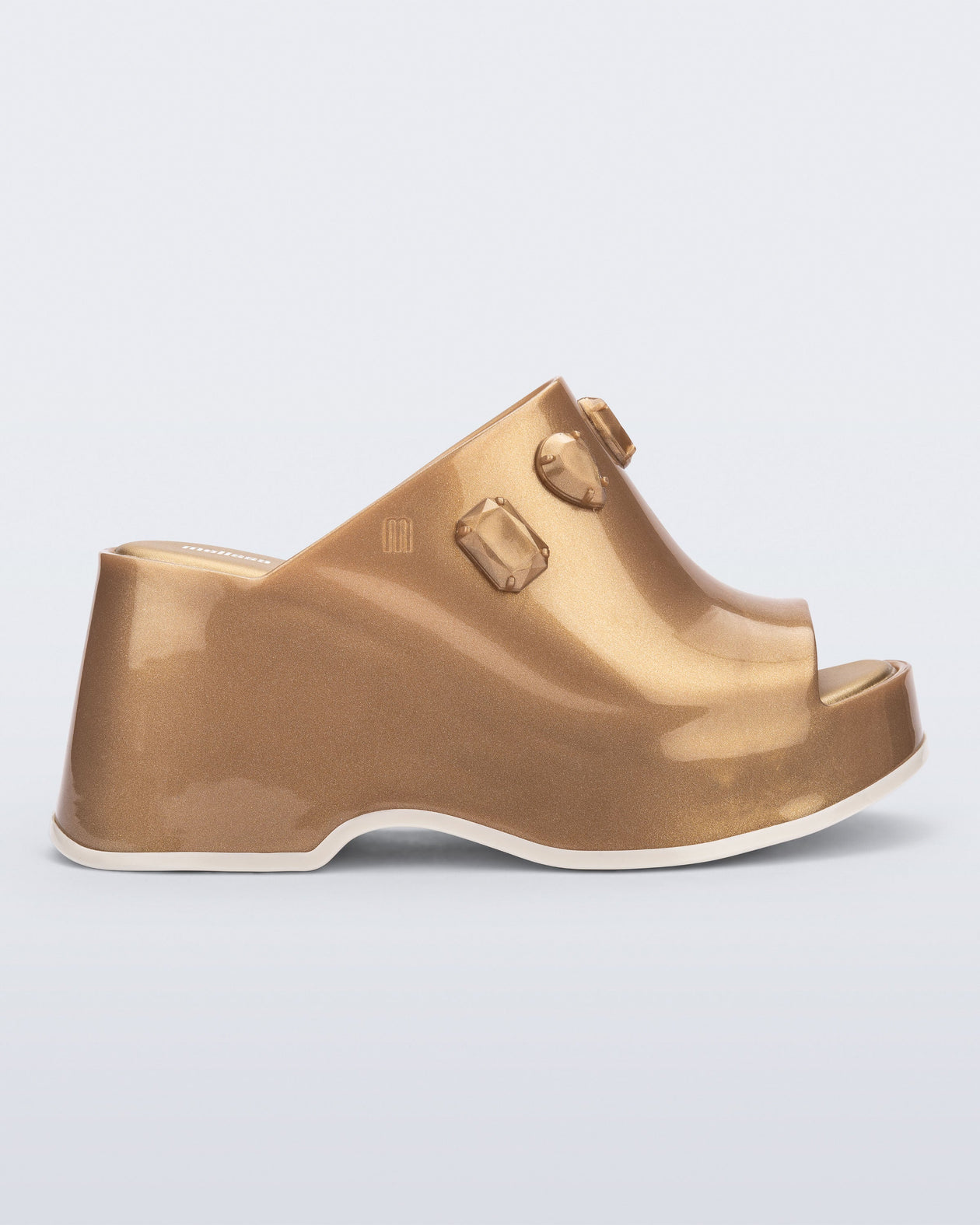 Side view of a metallic gold Patty Stones + Undercover platform open toe mule with beige sole and stone embellishments on upper.