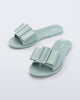 Angled view of a pair of blue green Babe slide sandals