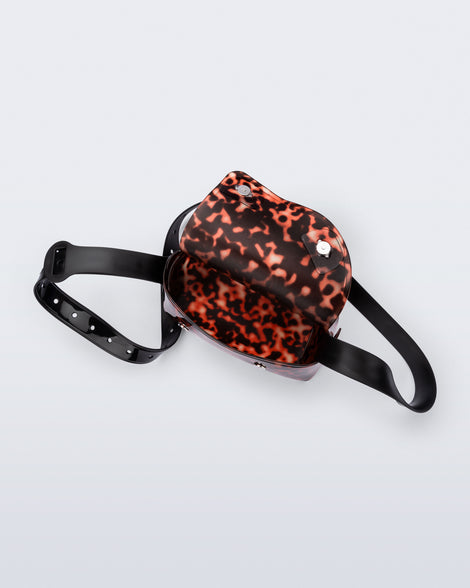 Top view of a tortoise Cross Bag with adjustable black strap