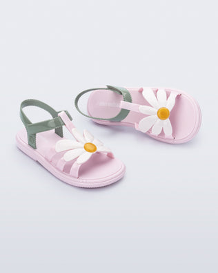 Angled view of a pair of pink and green kids Hip Bloomy sandal.