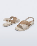 Back and angled view of a pair of beige Cleo sandals with back strap and crisscross top straps