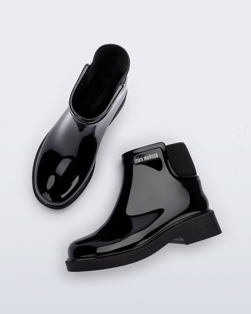 Top and side view of a pair of black Chelsea II kids boots