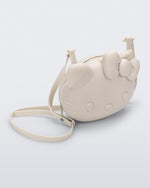 Angled view of a beige Hello Kitty + Friends Cute Bag with the face of Hello Kitty