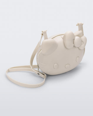 Angled view of a beige Hello Kitty + Friends Cute Bag with the face of Hello Kitty