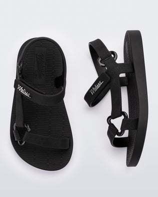 Top and side view of a pair of black Sun Downtown baby sandals