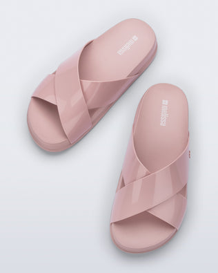 Top view of a pair of pink Cozy Cross sandals with crisscross top straps