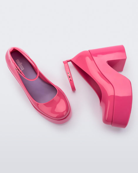 Side and top view of a pair of pink Doll Heel women's platform shoes.