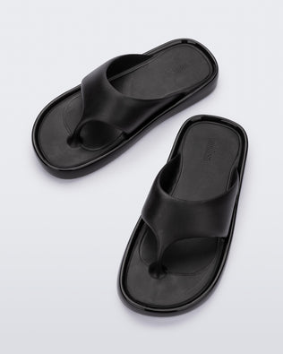 Top view of a pair of black Float flip flops
