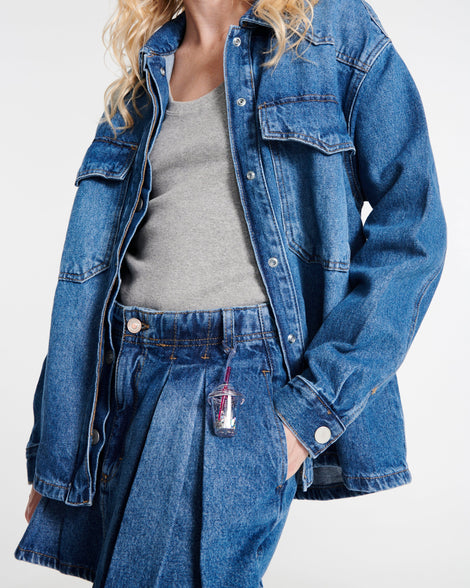 Model in jeans and a jean jacket wearing a Drink Charm on their pants belt loop