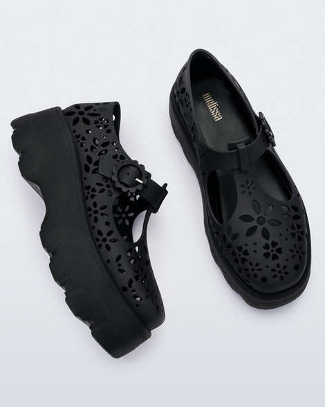 Side and top view of a pair of black Kick Off Lace women's platform shoe with buckle.