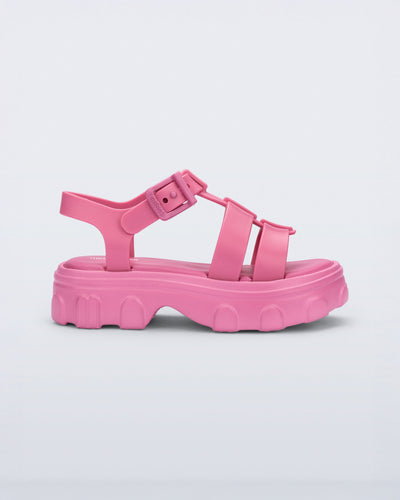 Side view of a pink Ella kids sandal with heel strap