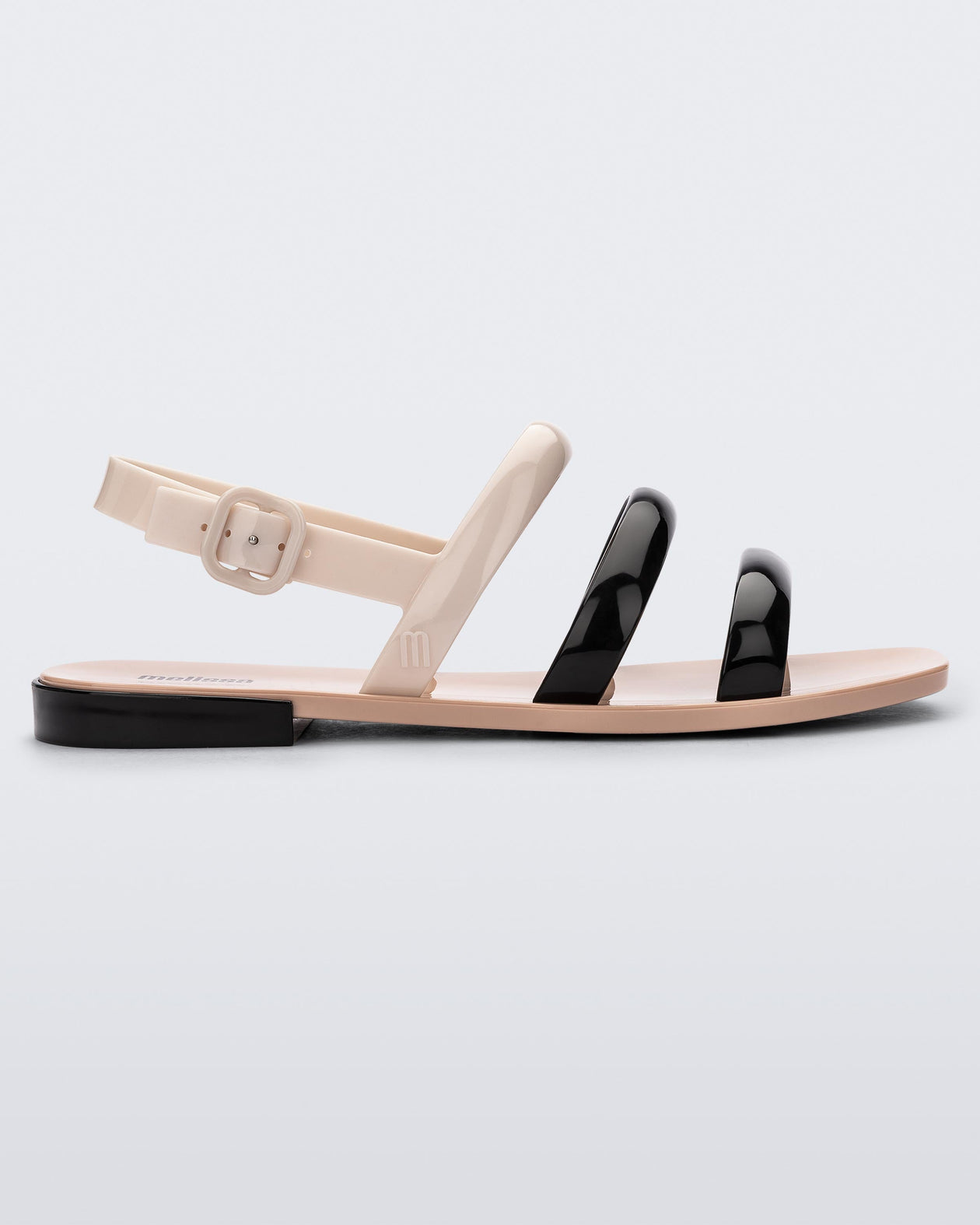 Side view of a black and beige Essential Wave women's sandal with adjustable buckle.