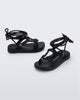 Side and angled view of a pair of black Kirk + Alexandre Pavao sandals with ankle strap