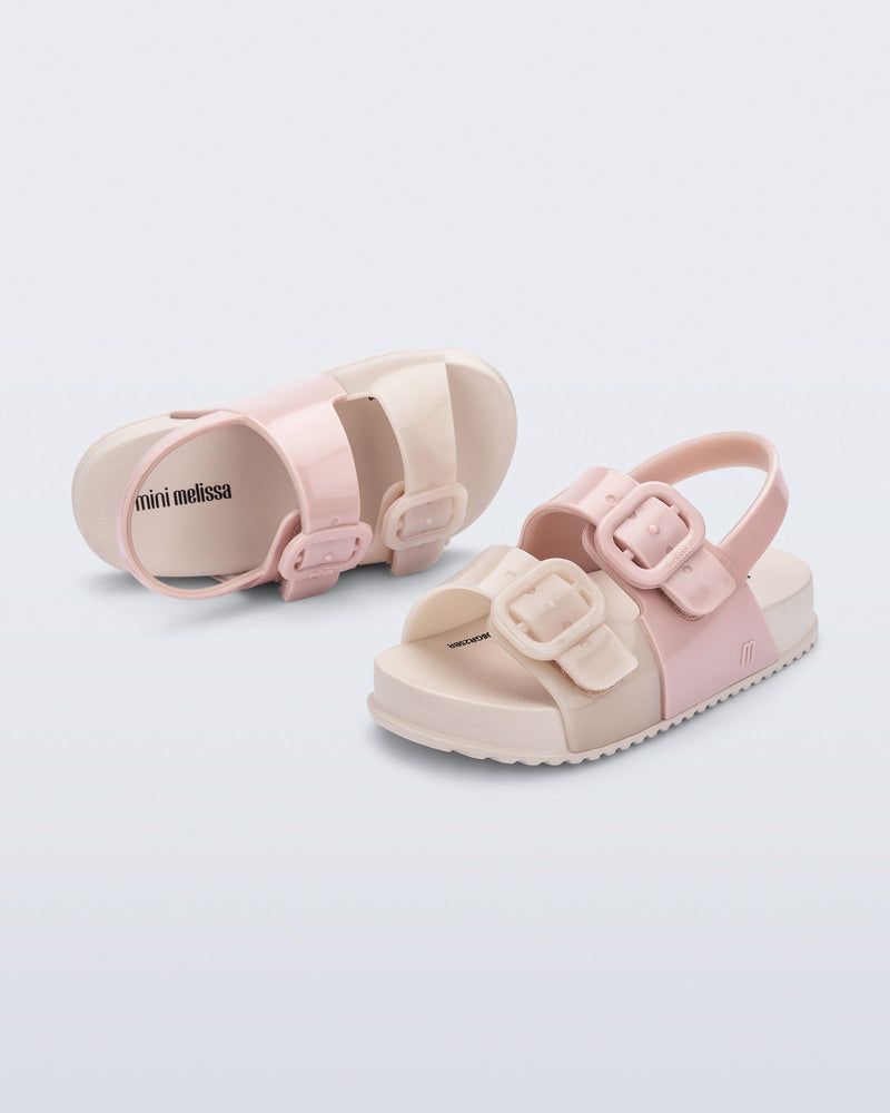 Top and side view of a pair of pink/beige Cozy baby slides