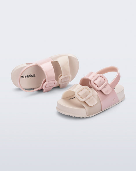 Top and side view of a pair of pink/beige Cozy baby slides