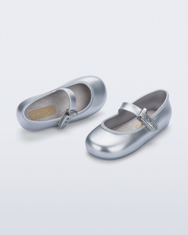 Side and top angled view of a pair of silver Soft Ballerina baby flats