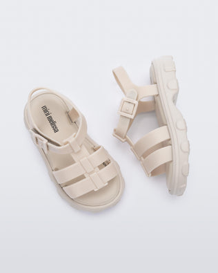 Side and top view of a pair of beige Ella baby sandals