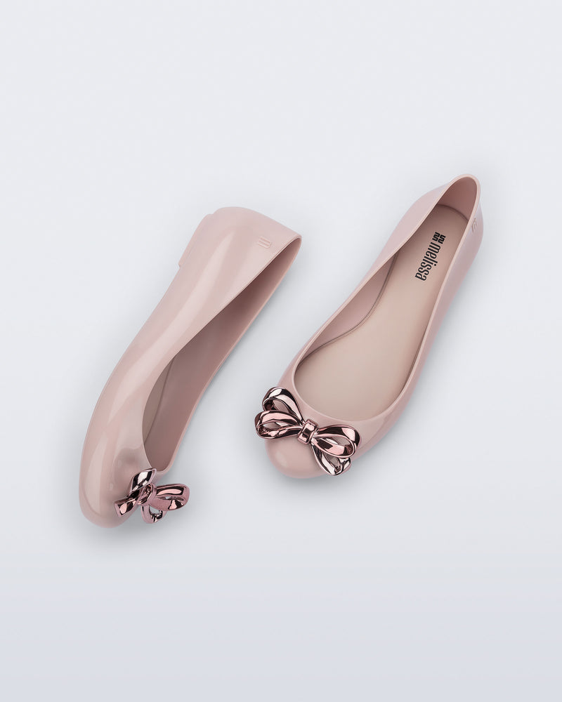 Side and top view of a pair of pink Sweet Love Glam ballerina flats with pink chrome bow