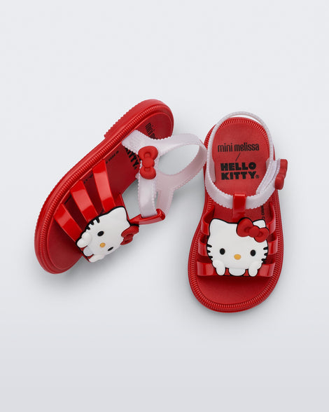Side and top view of a pair of red Hip + Hello Kitty and Friends sandals with white ankle straps and Hello Kitty on upper