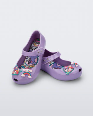 Angled view of a pair of lilac Ultragirl + Hello Kitty and Friends baby flats with Hello Kitty Friends on the upper