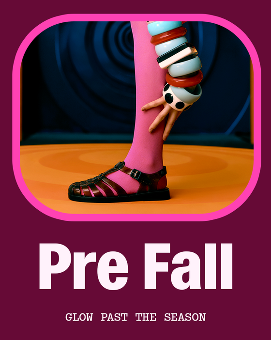 A promotional graphic with a magenta border around a stylized photo of a person's lower leg wearing bright pink tights and black sandals, with a hand touching the tibia. Large white text reads 'Pre Fall' and smaller text below says 'GLOW PAST THE SEASON' on a dark magenta background.