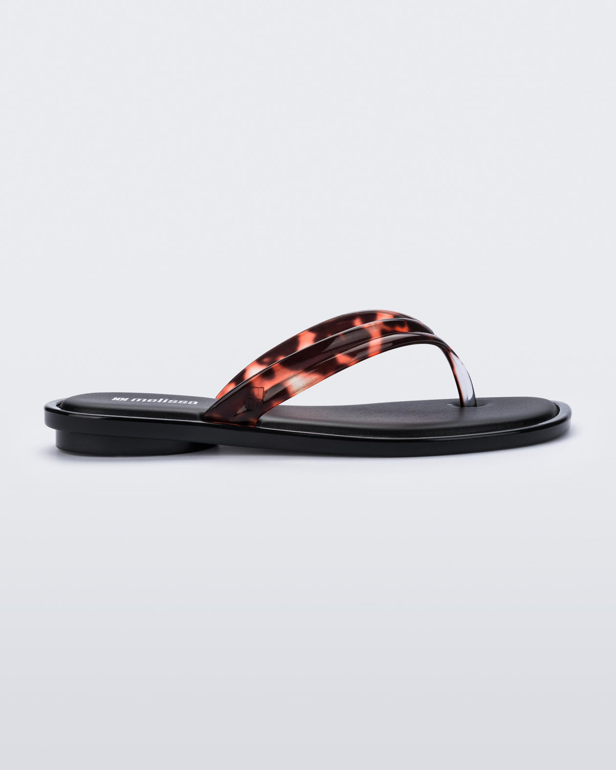 Side view of a tortoise Wave Flip Flop with small heel and black sole