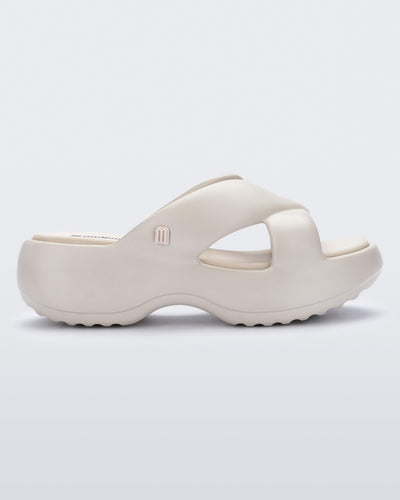 Side view of a beige Free Rise platform slide sandal