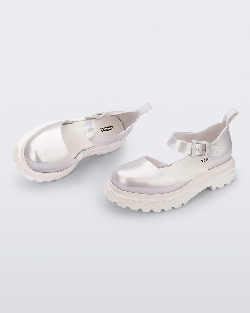 Side and angled view of a pair pearly white Ellie ankle strap loafers