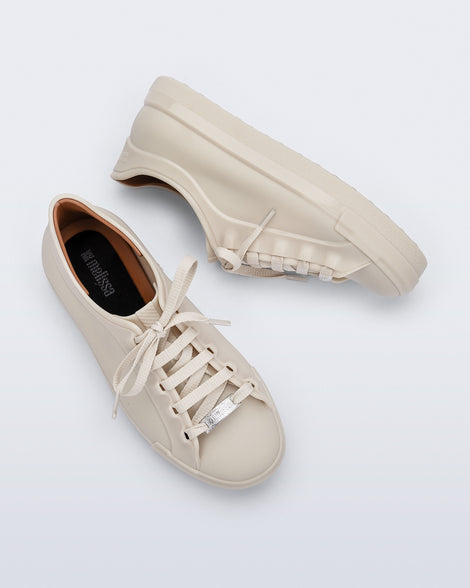 Top and side view of a pair of beige Wow Sneakers with beige laces