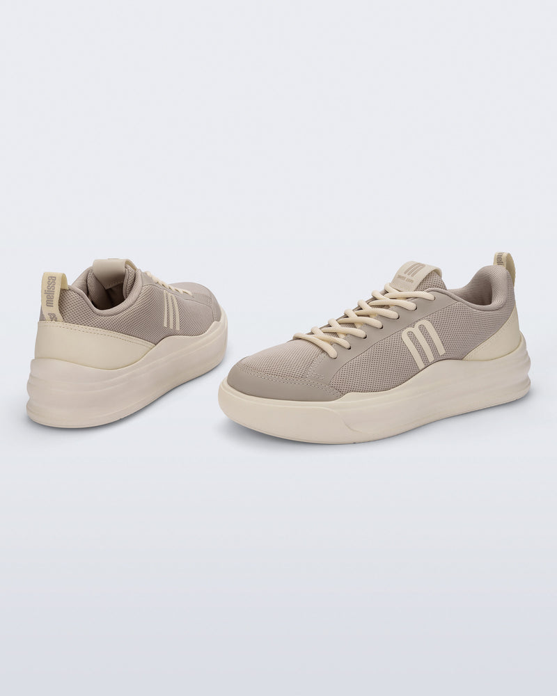 Back and angled view of a pair of beige X Mood sneakers