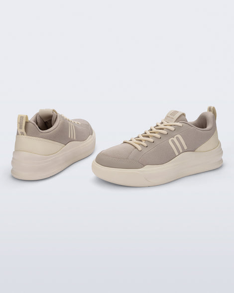 Back and angled view of a pair of beige X Mood sneakers
