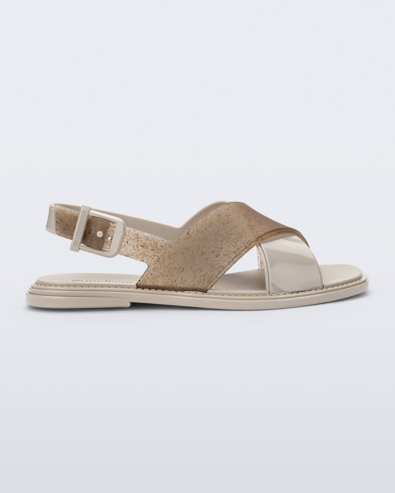 Side view of a beige Cleo sandal with back strap and crisscross top straps