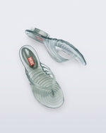 Top and side view of a pair of transparent green Flip Flop + Diesel sandals