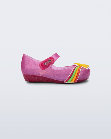 Side view of a glitter pink Ultragirl Colors baby flat with yellow star and rainbow on top