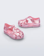 Side and angled view of a pair of pearly pink Starry baby sandals