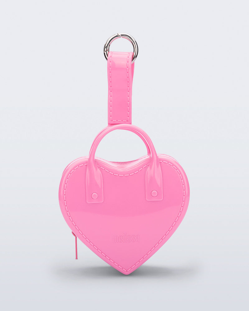 Front view of a pink Heartbeat Pocket bag charm