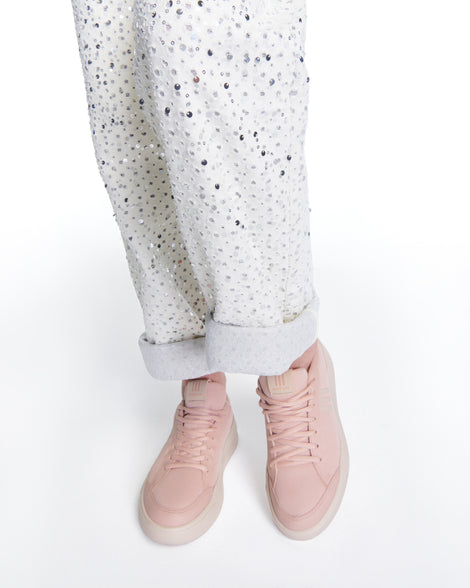 Model's legs wearing a pair of pink X Mood sneakers