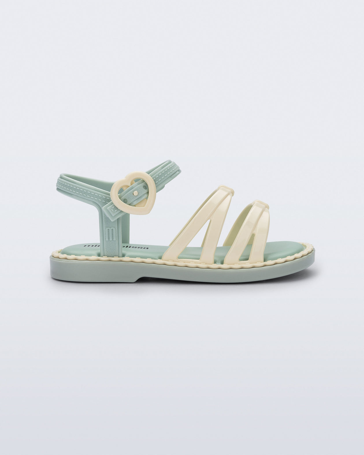 Side view of a green Aurora baby sandal with beige trim, straps and buckle